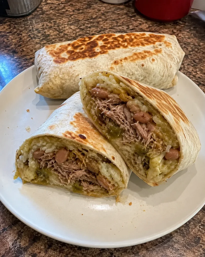 Chili Verde Hatch Burritos filled with tender pork, rice, pinto beans, roasted green chile sauce, and melted Monterey Jack
