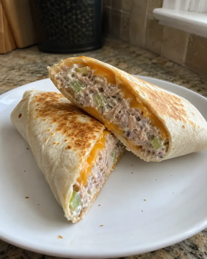 Tuna Melt Wrap cut in half with creamy tuna filling and melted cheddar