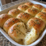 Golden mozzarella-stuffed bread rolls with a soft interior and garlic-butter topping