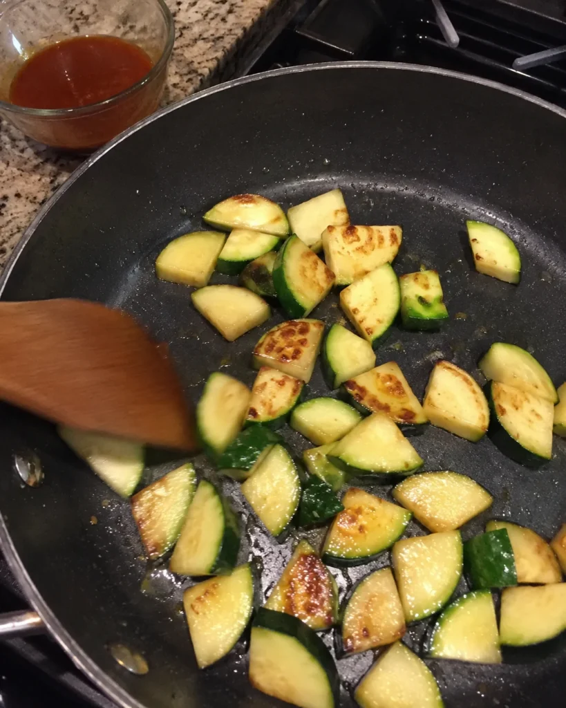 Zucchini browning in a skillet for Zucchini Stir-Fry