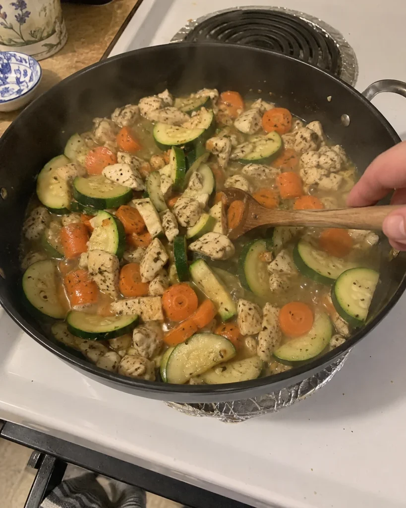Chicken, zucchini, and carrots simmering in broth for Gentle GLP-1 Dinners