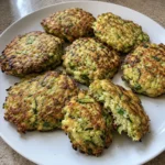 Homemade Air Fryer Zucchini Fritters with Parmesan and green onion on a white plate