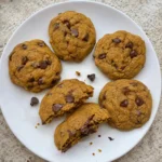 Fall Cookies arranged on a plate with one broken open to show the soft center