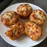 Cut Lunchbox Pizza Muffins showing mozzarella, pizza sauce, herbs, and chopped pepperoni