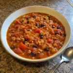 Bowl of Easy Turkey Pumpkin Chili with black beans and browned ground turkey