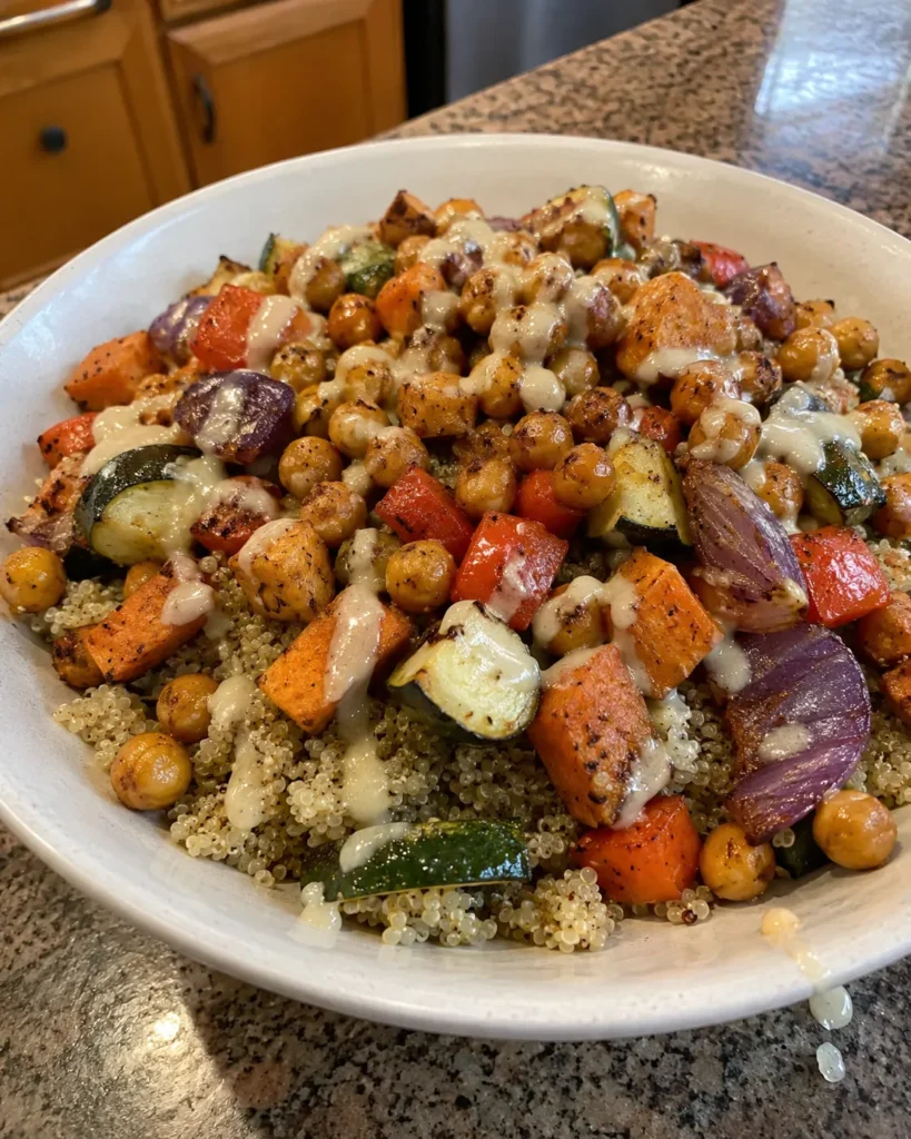 High-Fiber dinner with quinoa, roasted chickpeas, sweet potato, zucchini, bell pepper, and lemon tahini dressing