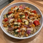 High-Fiber dinner bowl topped with roasted chickpeas, vegetables, sweet potato, and tahini dressing