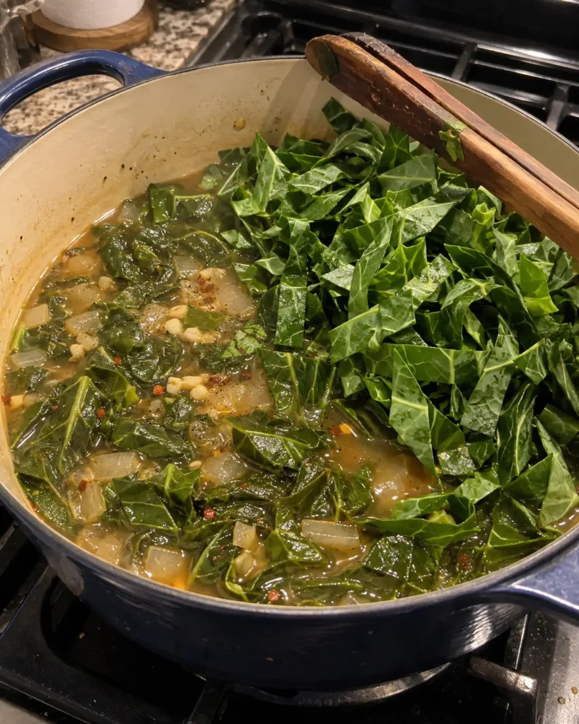 Adding sliced collards to vegetable broth for Vegan Southern Collard Greens.