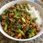 Close view of Firecracker Ground Chicken with broccoli and rice in a white bowl