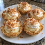 Close-up of Mini Coconut Cream Pie Tarts with flaky phyllo shells and toasted coconut