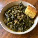 Bowl of Vegan Southern Collard Greens with tender dark green leaves and savory broth.
