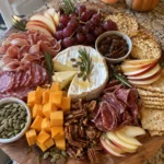 Fall Charcuterie Board close-up with cheese, salami, fruit, crackers, and fig jam
