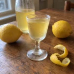 Small frosted glass of Homemade Limoncello with lemon peel