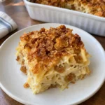 Square serving of Noodle Kugel with tender egg noodles and golden raisins