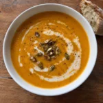 close-up of roasted butternut squash soup with bread on the side