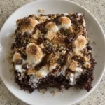 Square recipe card photo of S’mores Poke Cake with gooey marshmallow filling