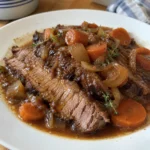 Close view of Rosh Hashanah Brisket Recipe with tender slices and glossy onion sauce